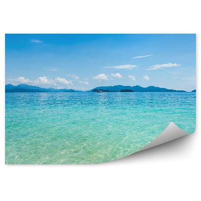 Fototapet Nisip Ocean Munți Cer Nori