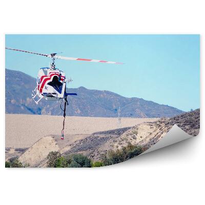 Fototapet perete Transport cu elicopter dealuri cer