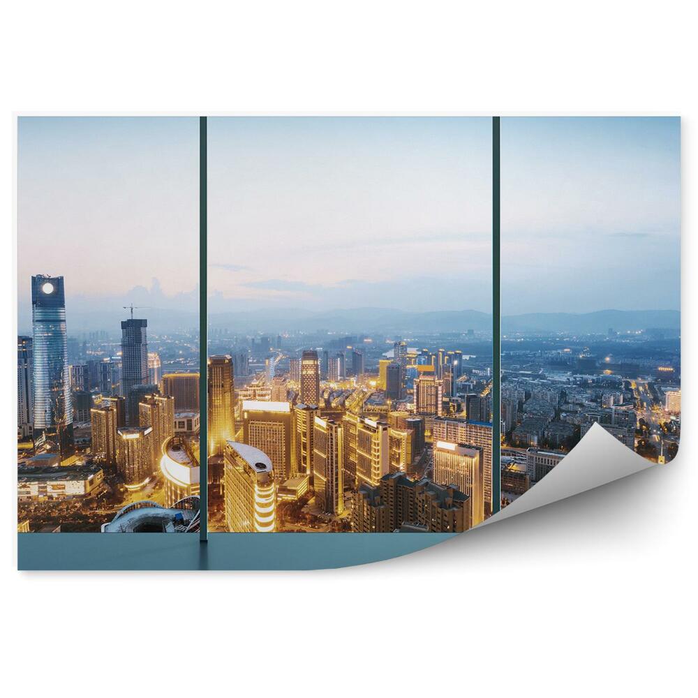 Decor fototapet Priveliște a orașului luminată de amurg de sus prin fereastră